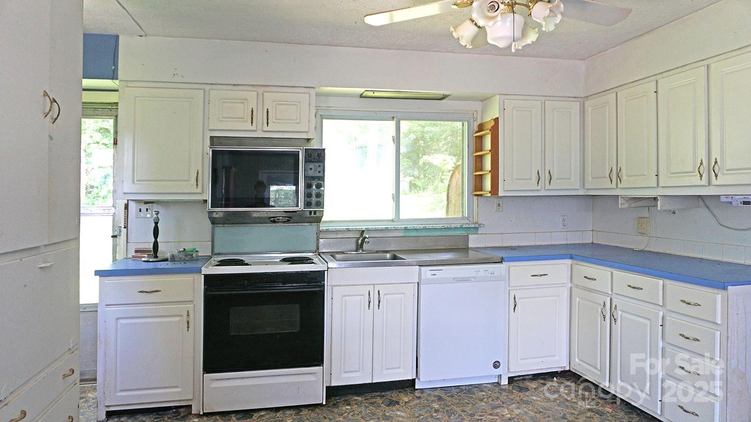57 Sizer Drive Mills River, NC 28759 - Photo 9 of 16 a kitchen with white cabinets and sink
