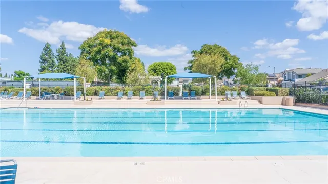 a view of swimming pool with outdoor seating and plants