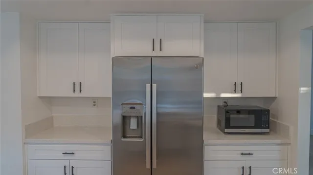 a kitchen with a refrigerator and a microwave