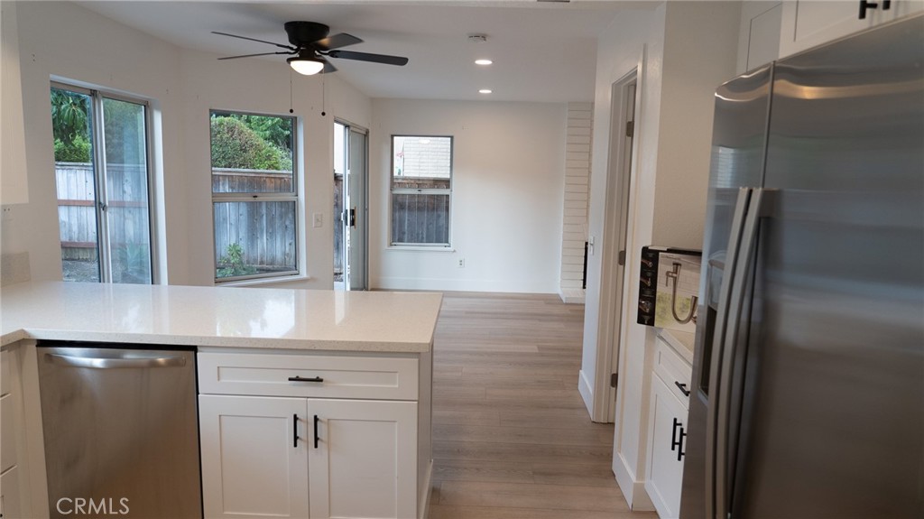 21 Fillmore Irvine, CA 92620 - Photo 6 of 36 a kitchen with stainless steel appliances granite countertop a refrigerator and a sink