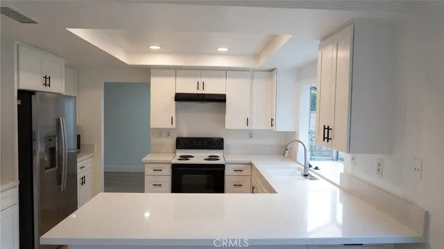 a kitchen that has a sink and a stove