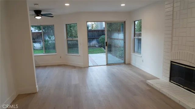 an empty room with wooden floor and a fireplace