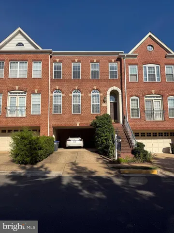 a front view of a house with yard and green space