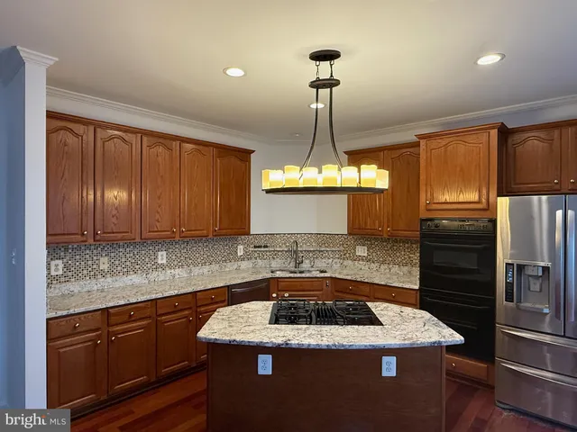 a kitchen with a stove sink and cabinets