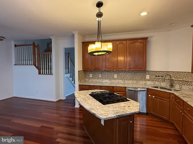 a kitchen with a stove sink and cabinets