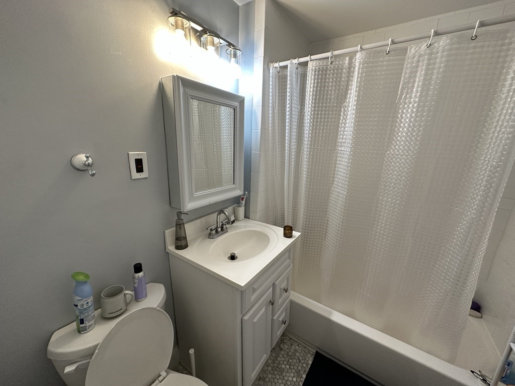 438 Washington Street, Unit 2 Boston, MA 02135 - Photo 6 of 12 a bathroom with a sink toilet and shower