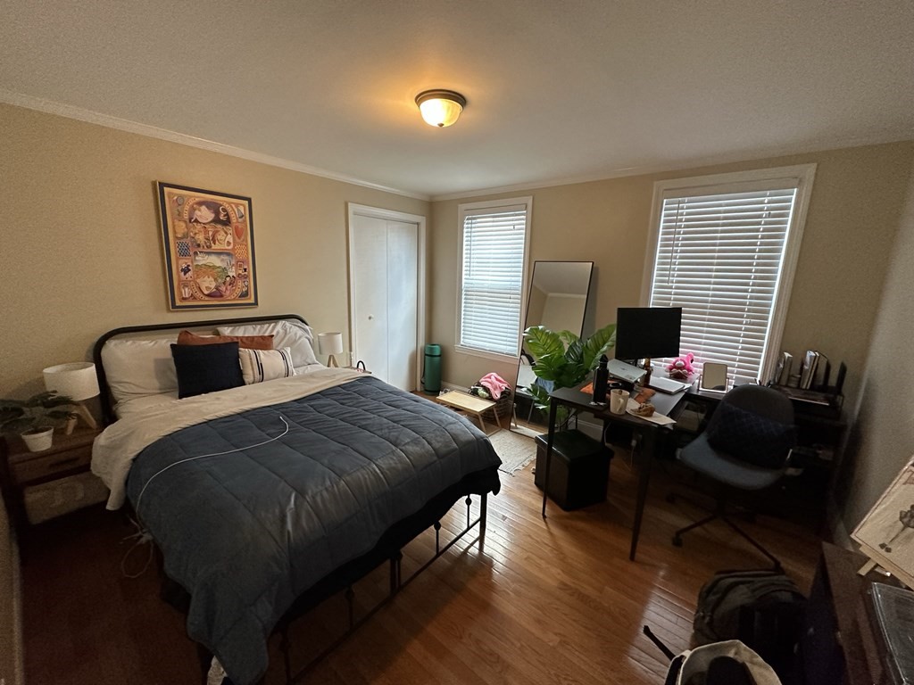 438 Washington Street, Unit 2 Boston, MA 02135 - Photo 9 of 12 a bedroom with a bed and a computer on the desk