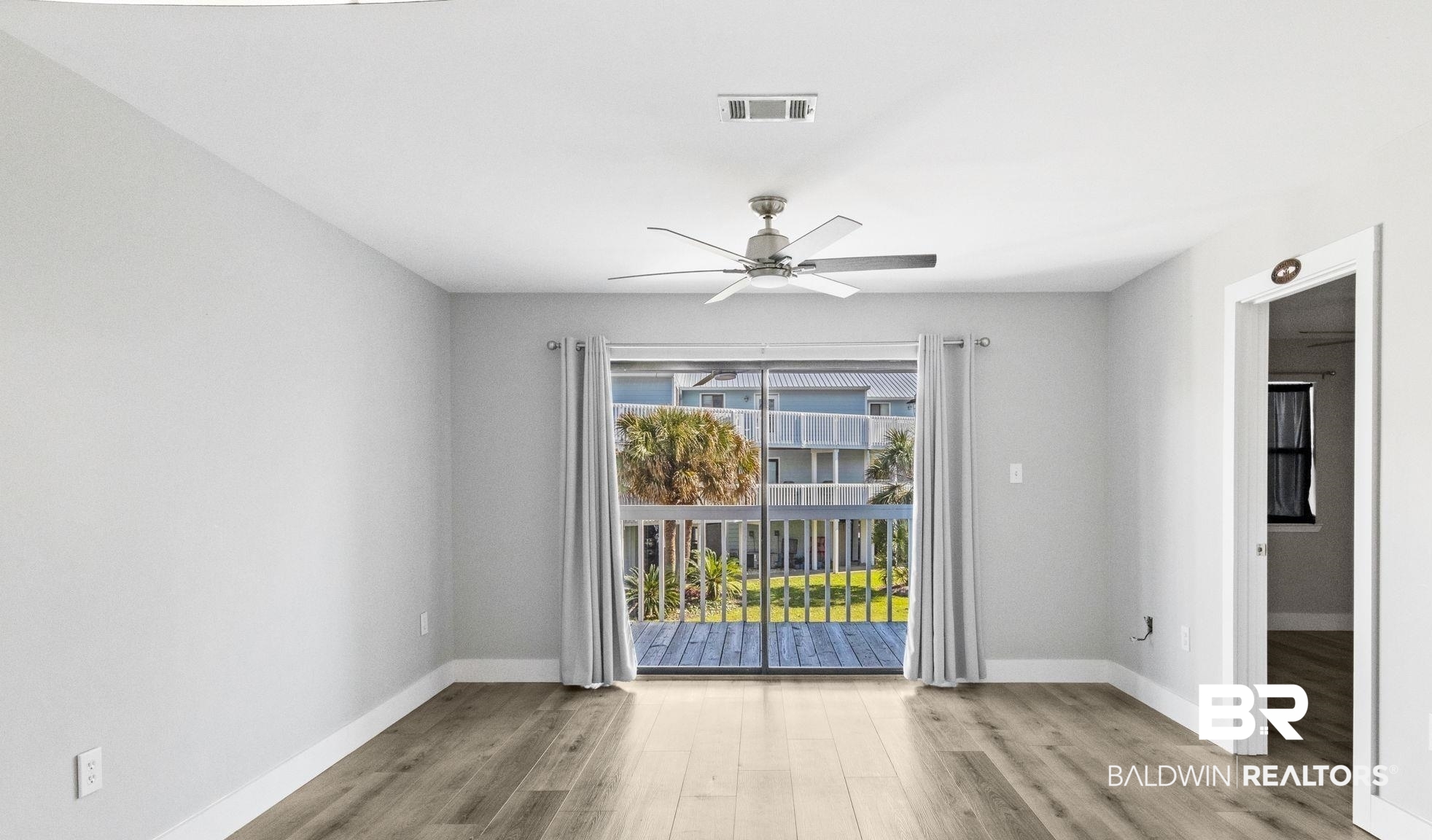 25861 Canal Road, Unit 77 Orange Beach, AL 36561 - Photo 17 of 48 Empty room featuring light wood-style floors and a ceiling fan