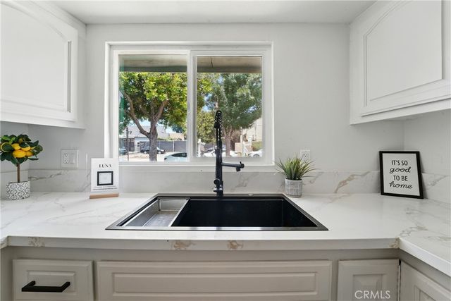 a kitchen with a sink and large window
