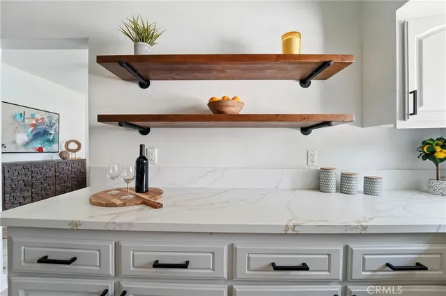 a kitchen with a potted plant on the counter and cabinets