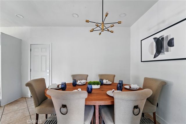 a view of a dining room with furniture and a chandelier fan