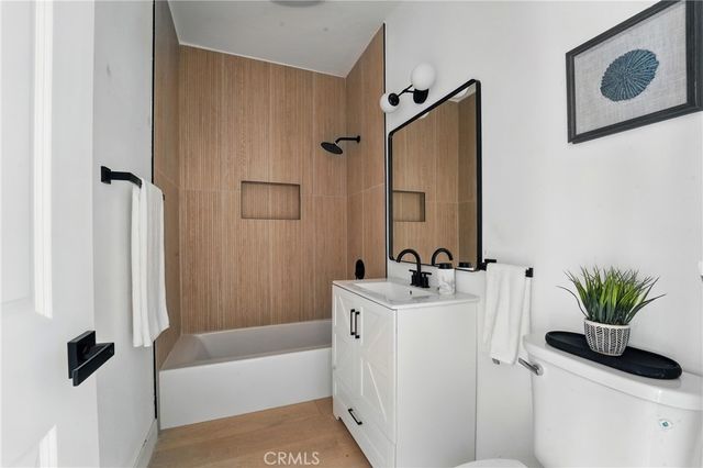 a bathroom with a sink a toilet and a tub