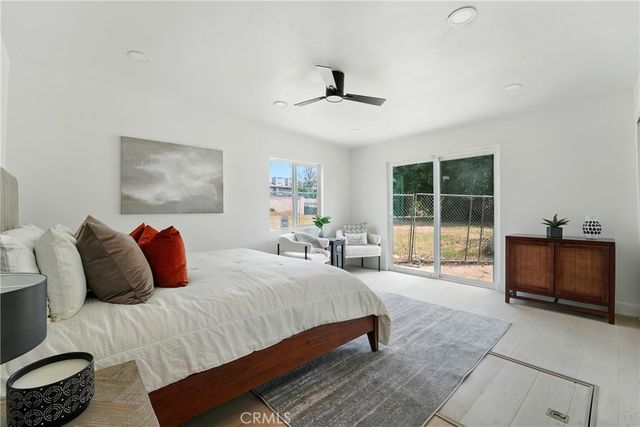 a bedroom with a bed and a painting on the wall