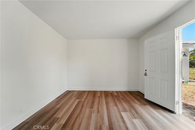 a view of an empty room and wooden floor