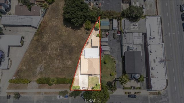 aerial view of a house with a yard