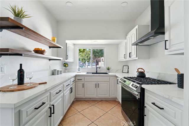 a kitchen with a sink stove and cabinets