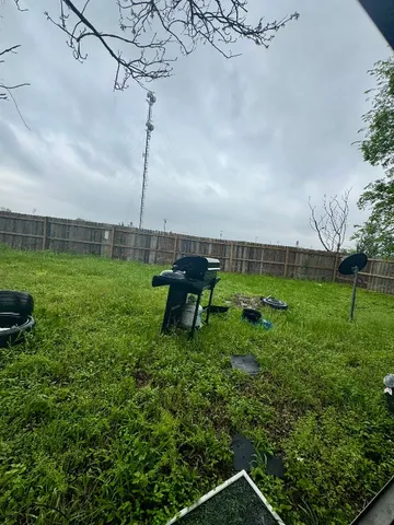 a view of a bench in a field of a house