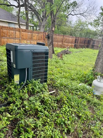 a backyard of a house with lots of green space and wooden fence