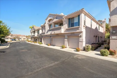 a front view of a house with a street