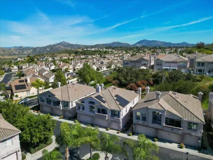 an aerial view of a houses with a city view