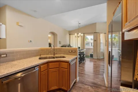 a kitchen with a sink a refrigerator and cabinets