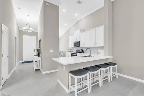 a kitchen with white cabinets and white appliances