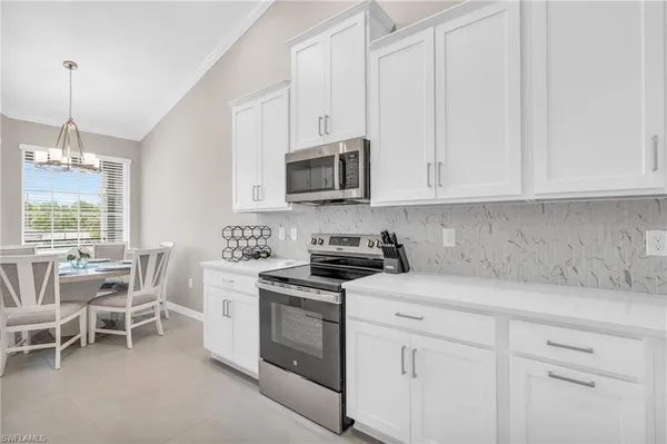 a kitchen with sink a stove and cabinets