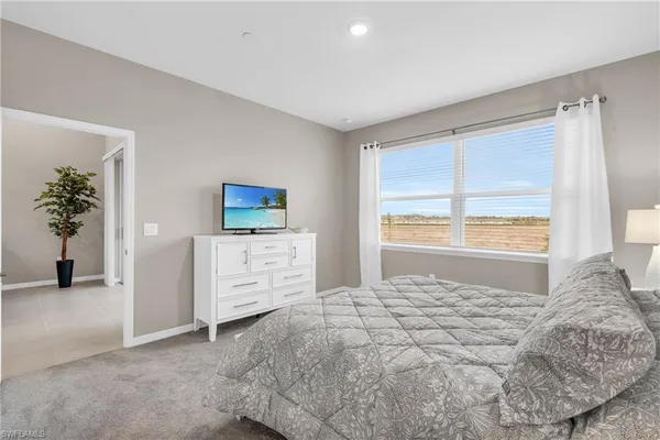 a bedroom with a bed and a night stand