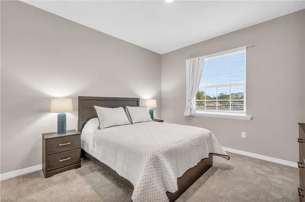 a bedroom with a bed and a tv