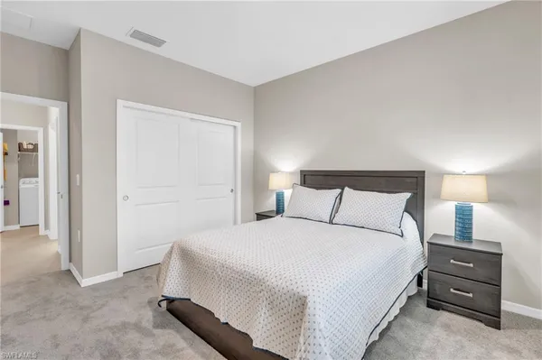 a bathroom with a toilet a sink a mirror and vanity