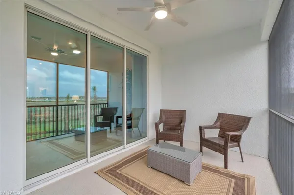 a view of a two chairs in the balcony