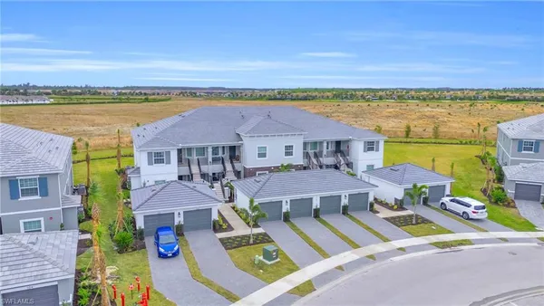 an aerial view of a house with swimming pool and outdoor seating