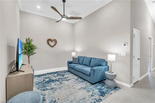 a living room with furniture a couch and a potted plant