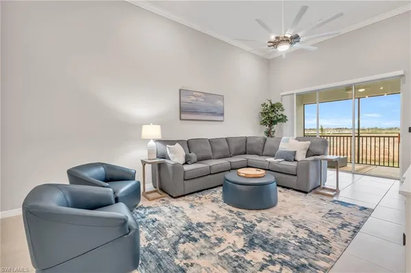 a living room with furniture a rug and a window