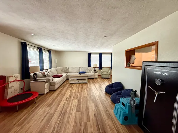 a living room with furniture and wooden floor