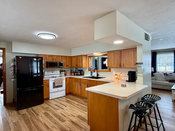 a kitchen with a sink a counter top space stainless steel appliances and cabinets