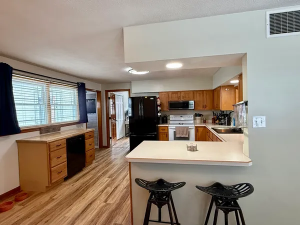 a large kitchen with a table and chairs in it
