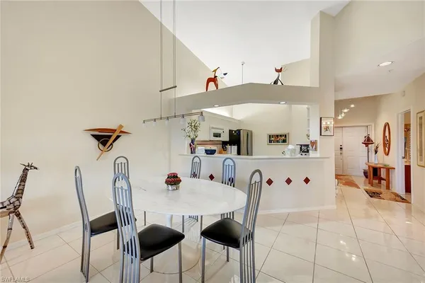 a view of a dining area with furniture and a kitchen