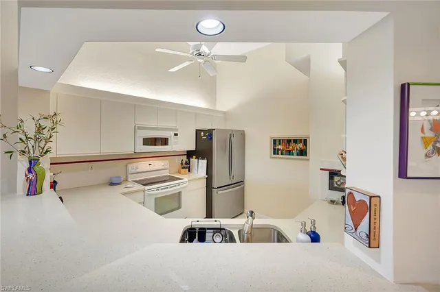 a kitchen with stainless steel appliances a refrigerator and microwave