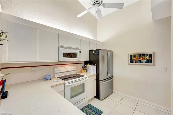 a kitchen with stainless steel appliances a refrigerator sink and stove