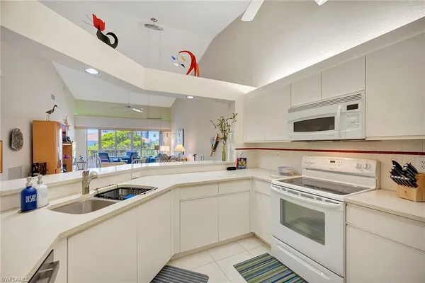 a kitchen that has a sink and a stove in it