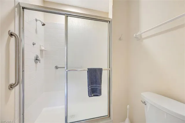 a bathroom with a glass shower door
