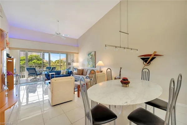 a view of a dining room with furniture and a potted plant
