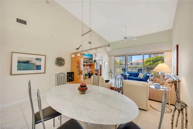 a view of a dining room with furniture and a large window