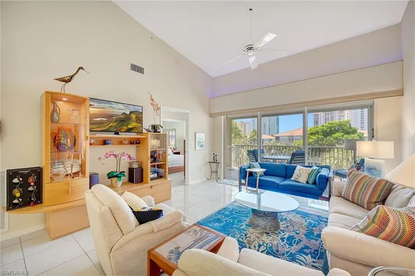 a living room with furniture large window and a table
