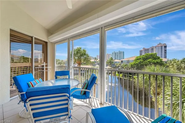 a view of a city from a balcony with furniture