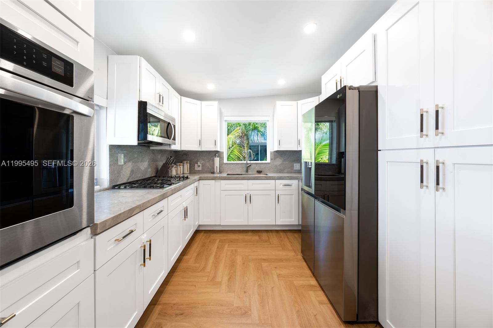 188 Orange Blossom Road Tavernier, FL 33070 - Photo 20 of 41 a large white kitchen with stainless steel appliances