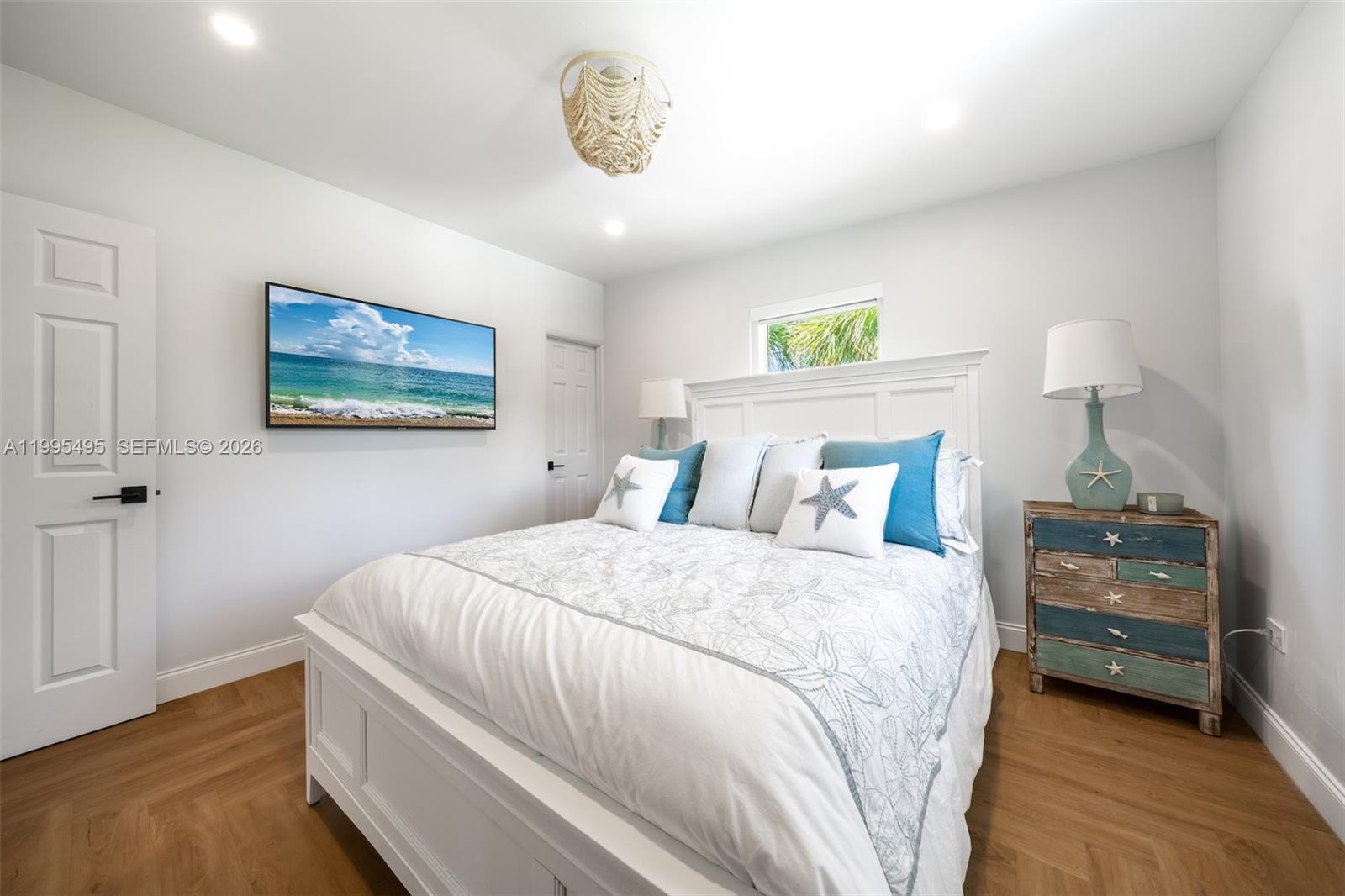 188 Orange Blossom Road Tavernier, FL 33070 - Photo 23 of 41 a bedroom with a bed and a painting on the wall