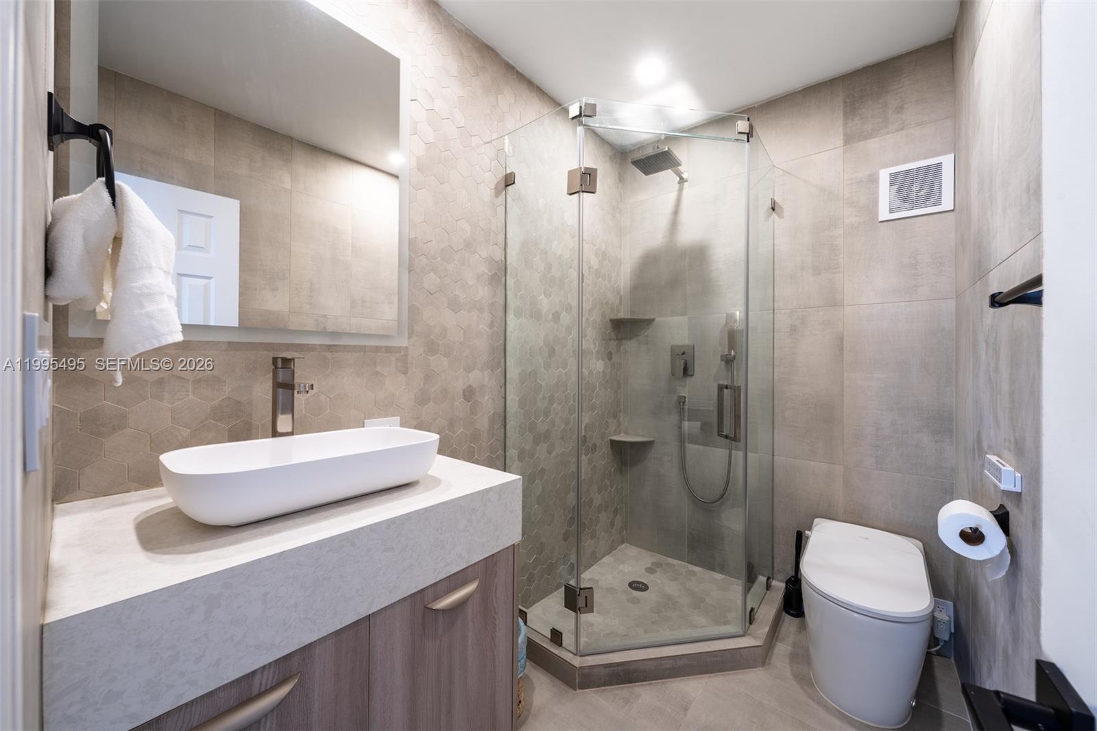 188 Orange Blossom Road Tavernier, FL 33070 - Photo 27 of 41 a bathroom with a sink a toilet and shower