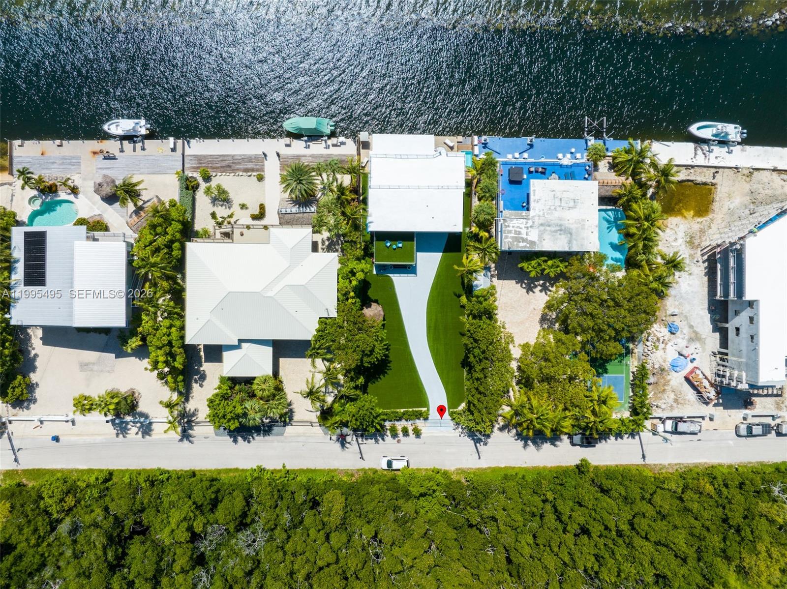188 Orange Blossom Road Tavernier, FL 33070 - Photo 9 of 41 an aerial view of a house with a yard and lake view
